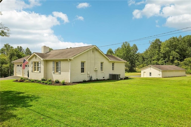 view of home's exterior with a garage, a lawn, and central air condition unit