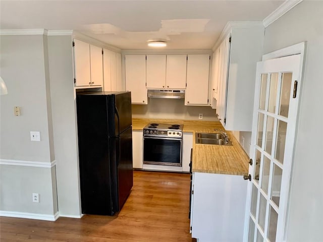4347 Barrington Pl, Macon, GA 31210 - kitchen with freestanding refrigerator, under cabinet range hood, range with electric cooktop, a sink, and light countertops