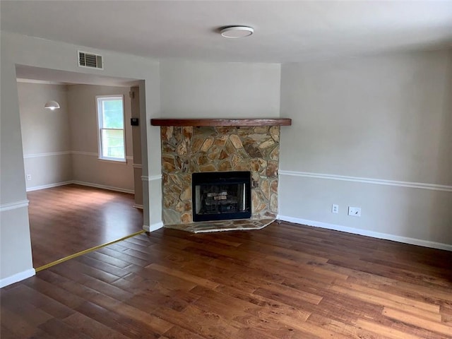 4347 Barrington Pl, Macon, GA 31210 - unfurnished living room featuring wood finished floors, baseboards, and a stone fireplace