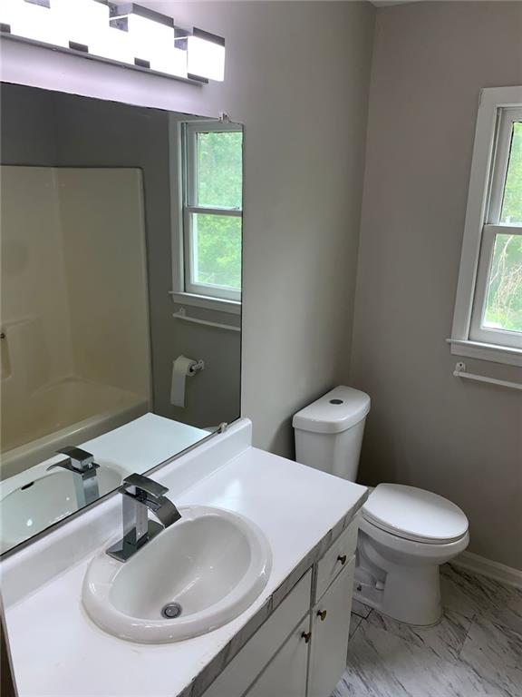 4347 Barrington Pl, Macon, GA 31210 - full bath featuring healthy amount of natural light, toilet, vanity, and marble look tiles