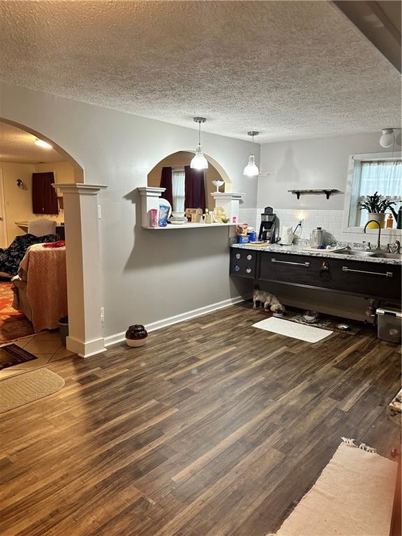 playroom with a textured ceiling and dark hardwood / wood-style flooring