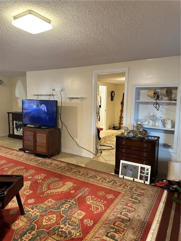 tiled living room featuring a textured ceiling