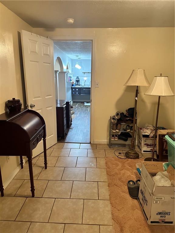 hallway featuring light tile patterned floors