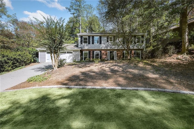 colonial inspired home featuring a front lawn and a garage