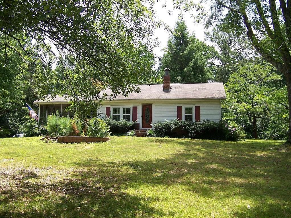 ranch-style house featuring a sunroom and a front yard