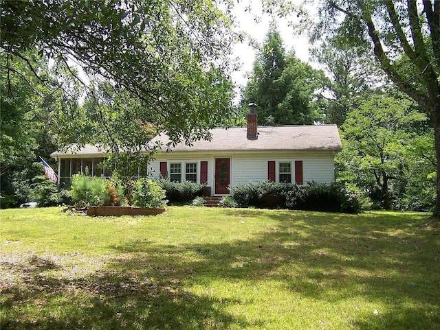 ranch-style house featuring a sunroom and a front yard