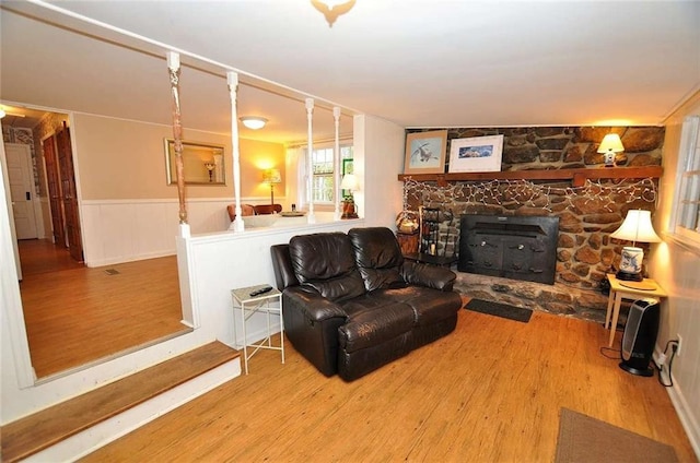 living room with a wood stove and hardwood / wood-style floors