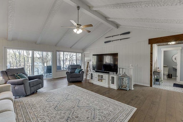 living room featuring vaulted ceiling with beams, hardwood / wood-style flooring, and ceiling fan