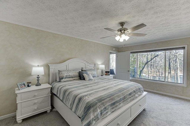 bedroom featuring crown molding, ceiling fan, carpet floors, and a textured ceiling