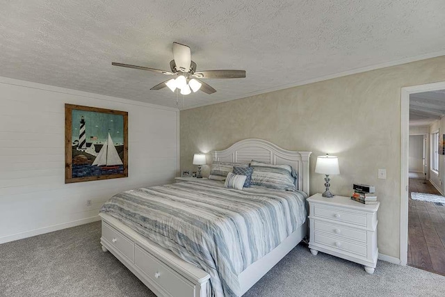 bedroom with carpet floors, ornamental molding, and a textured ceiling