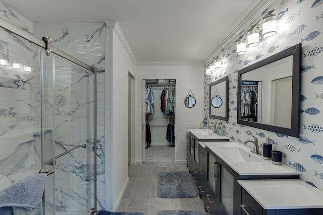 bathroom with vanity, crown molding, and a shower with door