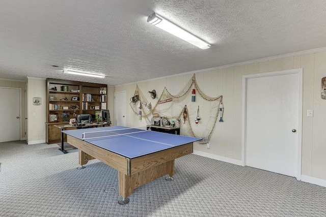 playroom featuring crown molding, carpet floors, and a textured ceiling