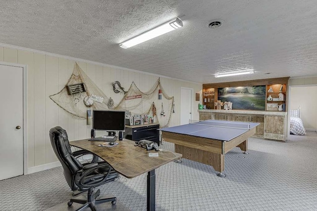 game room featuring crown molding, light colored carpet, and a textured ceiling