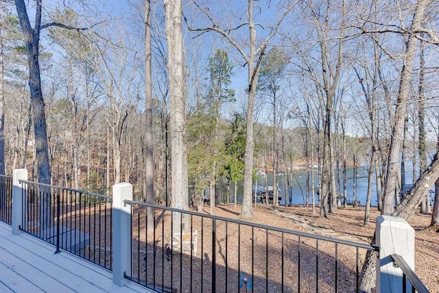 wooden terrace featuring a water view