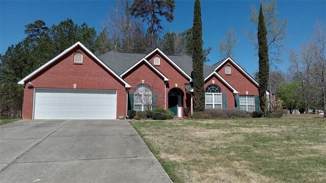 view of front property with a front yard and a garage