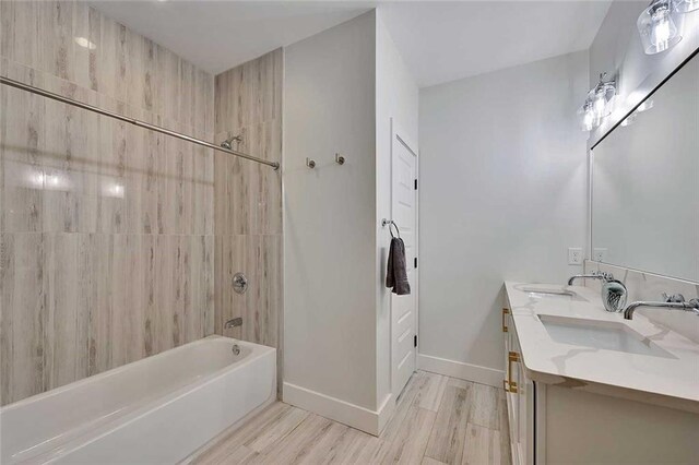 1455 Rucker Cir, Woodstock, GA 30188 - bathroom with wood finished floors, bathing tub / shower combination, baseboards, and a sink