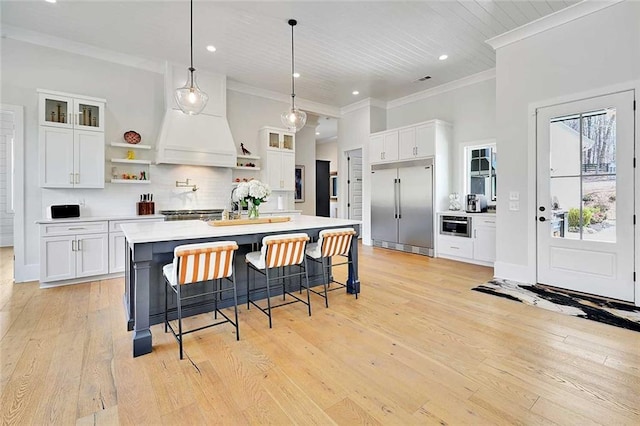 1455 Rucker Cir, Woodstock, GA 30188 - kitchen with open shelves, white cabinets, ornamental molding, and built in fridge
