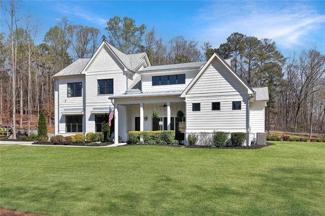 1455 Rucker Cir, Woodstock, GA 30188 - view of front of house with central air condition unit, a ceiling fan, and a front yard