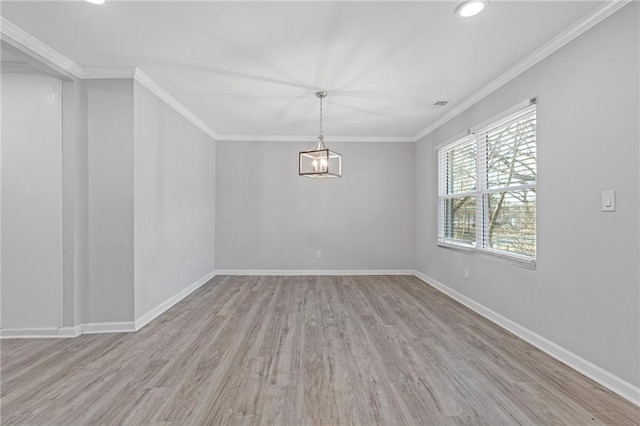 unfurnished room with ornamental molding, an inviting chandelier, and light hardwood / wood-style flooring