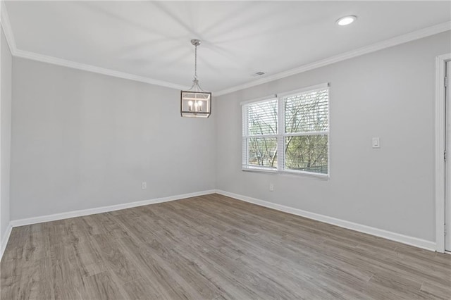 unfurnished room with crown molding, a chandelier, and light wood-type flooring