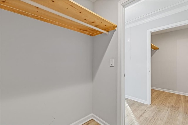 spacious closet featuring light hardwood / wood-style flooring