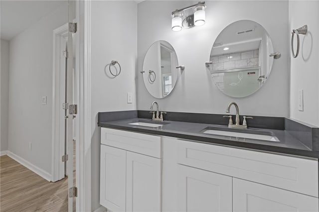 bathroom with a shower with door, vanity, and hardwood / wood-style floors