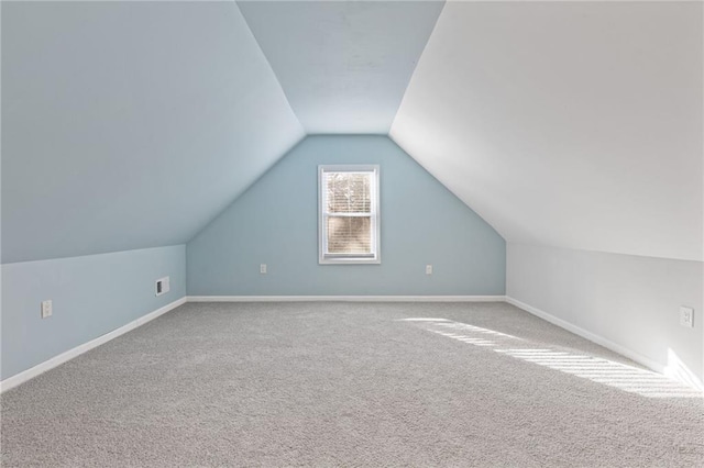 bonus room with lofted ceiling and carpet floors