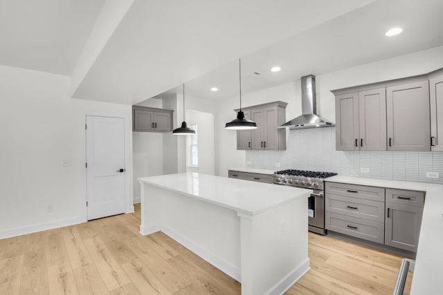 474 Maxwell Rd, Roswell, GA 30075 - kitchen with wall chimney exhaust hood, high end stainless steel range oven, gray cabinets, a center island, and tasteful backsplash