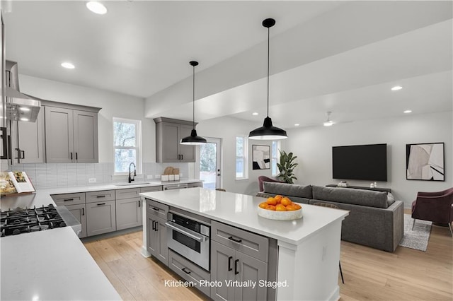 474 Maxwell Rd, Roswell, GA 30075 - kitchen featuring gray cabinetry, stainless steel oven, light countertops, light wood-style flooring, and recessed lighting