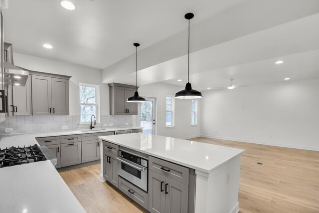 474 Maxwell Rd, Roswell, GA 30075 - kitchen with gray cabinets, light wood-style floors, light countertops, tasteful backsplash, and oven