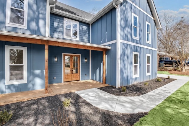 exterior space with board and batten siding and french doors