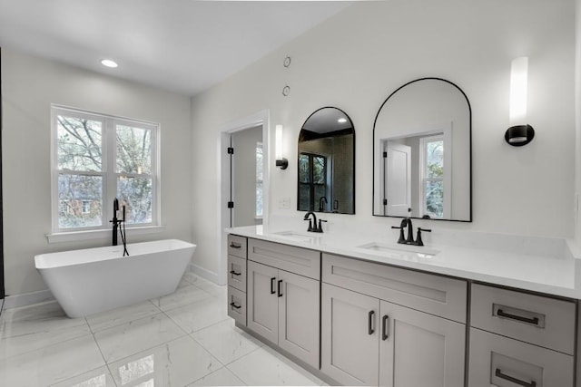 474 Maxwell Rd, Roswell, GA 30075 - bathroom with double vanity, a soaking tub, plenty of natural light, marble look tile flooring, and recessed lighting