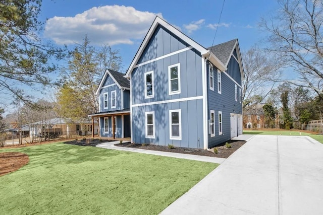 474 Maxwell Rd, Roswell, GA 30075 - rear view of property with board and batten siding, a lawn, and driveway