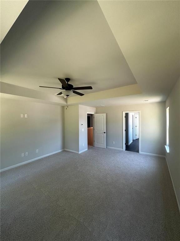 empty room featuring baseboards, carpet floors, and ceiling fan