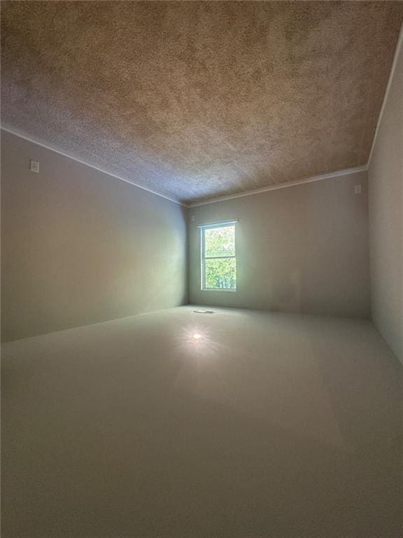 unfurnished room featuring a textured ceiling and crown molding