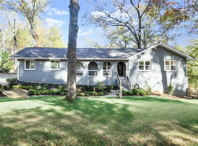 ranch-style home featuring a front yard