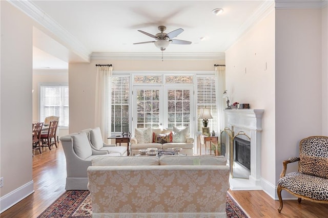 living room featuring crown molding, ceiling fan, and hardwood / wood-style floors