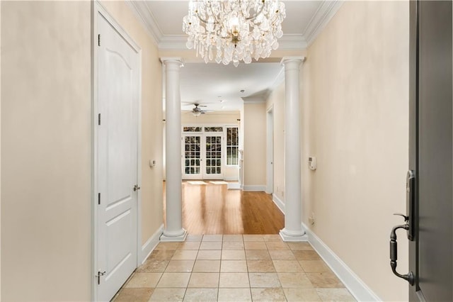 hall featuring ornamental molding, decorative columns, light tile patterned floors, baseboards, and a chandelier