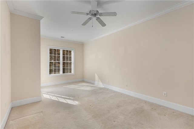 carpeted empty room with crown molding and ceiling fan