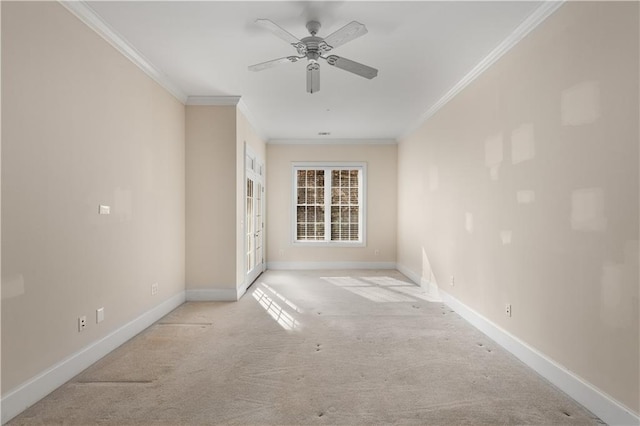 spare room with ceiling fan, light colored carpet, and ornamental molding