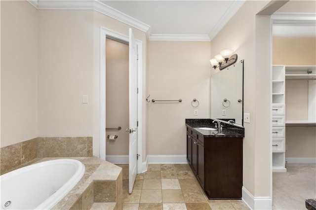 full bathroom with vanity, a garden tub, ornamental molding, and baseboards