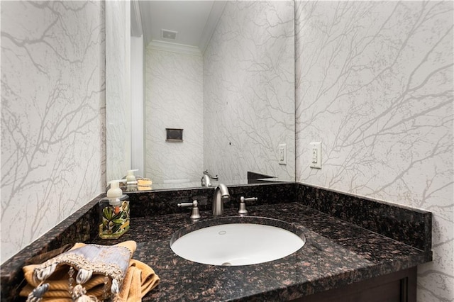 bathroom with ornamental molding and vanity