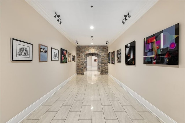 corridor with track lighting and ornamental molding