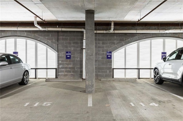 parking garage featuring concrete block wall