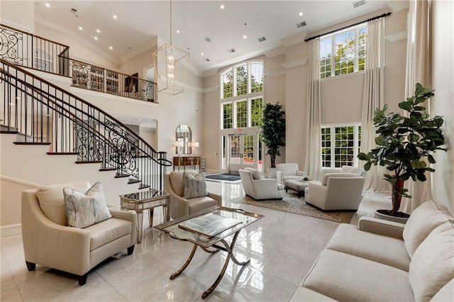 building lobby with ornamental molding, a towering ceiling, stairs, and recessed lighting