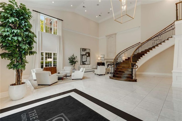 foyer with a high ceiling, stairs, baseboards, a chandelier, and recessed lighting