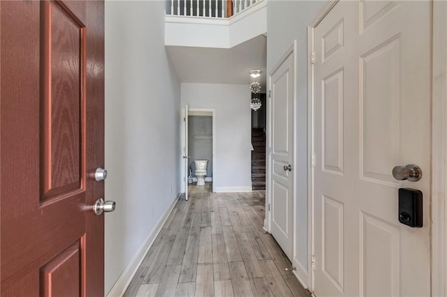 foyer entrance with baseboards and light wood finished floors