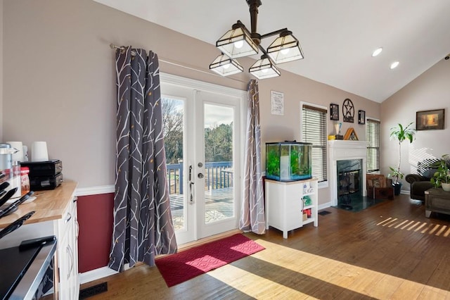 interior space with french doors, lofted ceiling, and hardwood / wood-style flooring