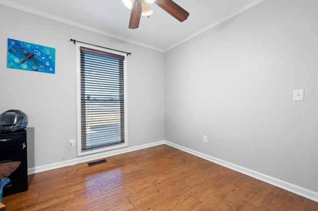 spare room featuring ceiling fan, crown molding, and hardwood / wood-style flooring