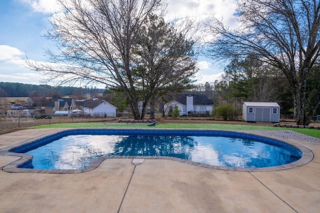 view of pool featuring a patio area and a shed